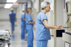 Hispanic male doctor looking at computer